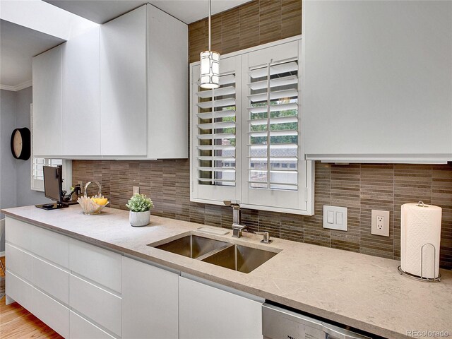 3481 S Race St, Englewood, CO 80113 - kitchen featuring white cabinetry, backsplash, pendant lighting, stainless steel dishwasher, and light stone counters