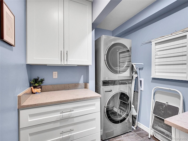 3481 S Race St, Englewood, CO 80113 - laundry room featuring estacked washer and dryer, cabinet space, and heating unit