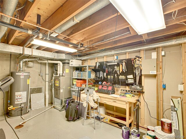 3481 S Race St, Englewood, CO 80113 - unfinished basement with water heater, a workshop area, and heating unit