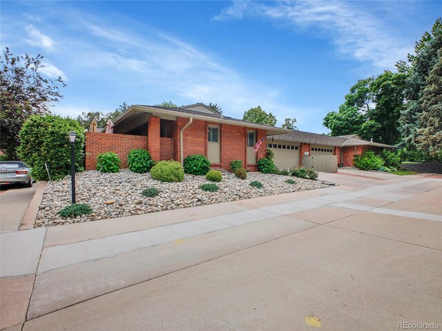 3481 S Race St, Englewood, CO 80113 - ranch-style house with brick siding, an attached garage, and driveway