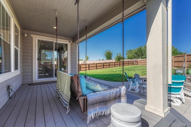 wooden deck featuring a lawn