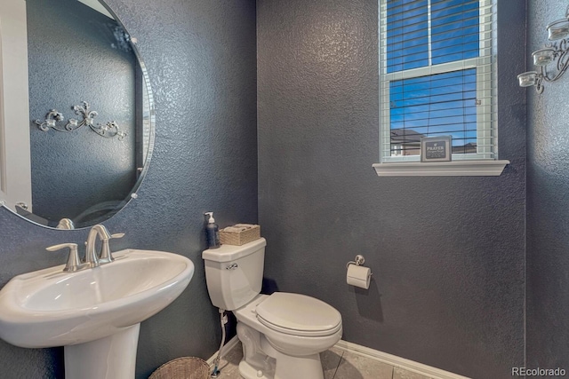 bathroom with sink, tile patterned floors, and toilet