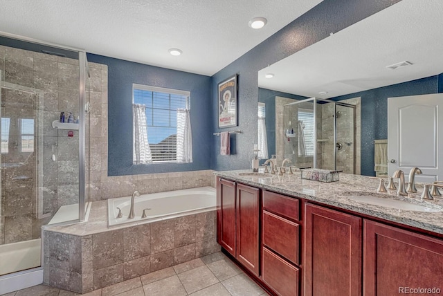 bathroom featuring tile patterned flooring, a textured ceiling, vanity, and separate shower and tub