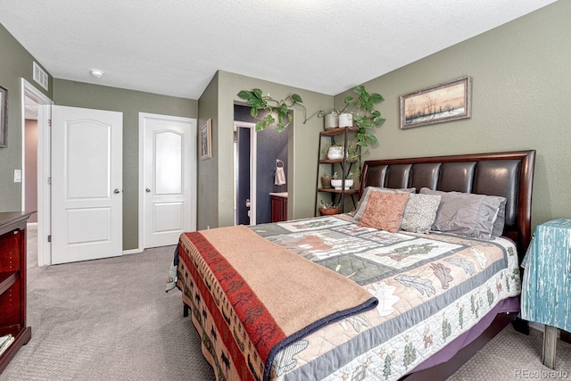 bedroom with a textured ceiling and carpet flooring