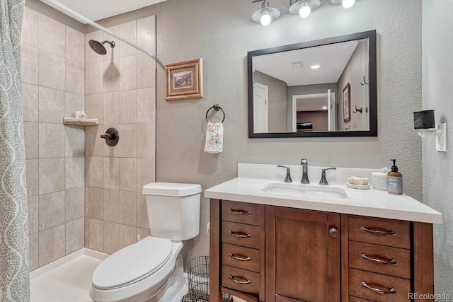 bathroom featuring a shower with shower curtain, vanity, and toilet