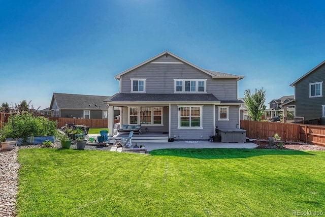 rear view of property with a lawn and a patio area