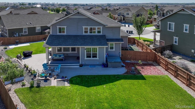 rear view of house featuring a lawn and a patio area