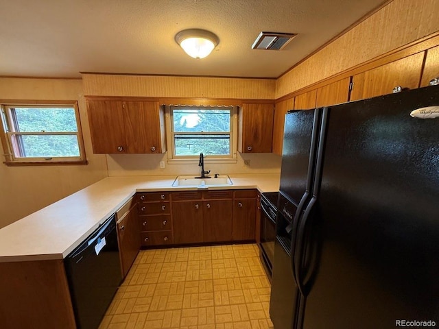 1013 Lexington Ln, Estes Park, CO 80517 - kitchen with black appliances, light countertops, brown cabinets, and a peninsula