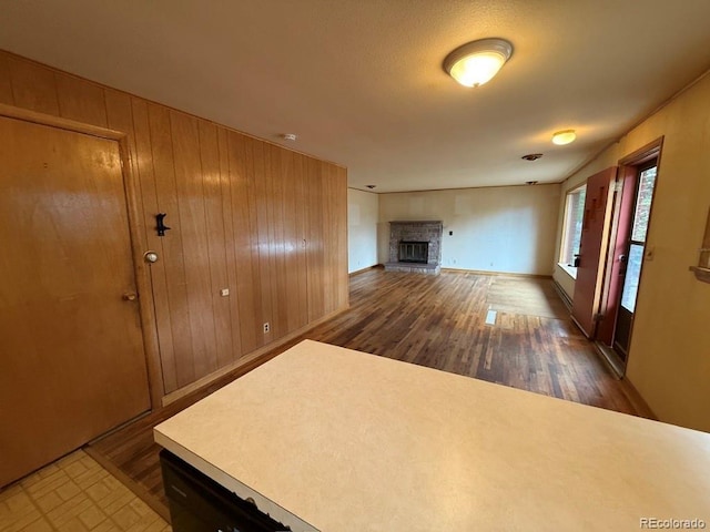 1013 Lexington Ln, Estes Park, CO 80517 - unfurnished living room with wood finished floors, a fireplace, and wood walls