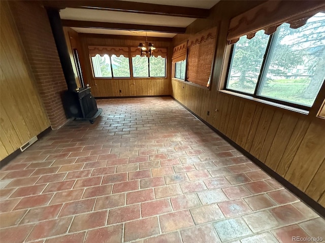 1013 Lexington Ln, Estes Park, CO 80517 - unfurnished sunroom featuring a chandelier, beam ceiling, and a wood stove