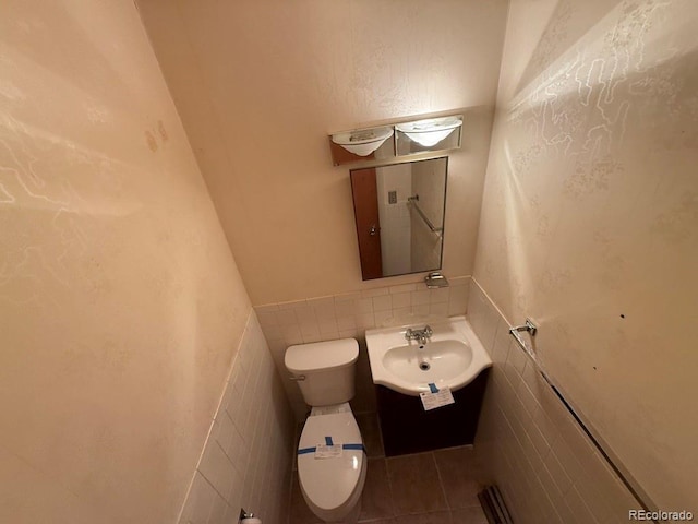 1013 Lexington Ln, Estes Park, CO 80517 - half bath featuring tile walls, vanity, tile patterned floors, and wainscoting