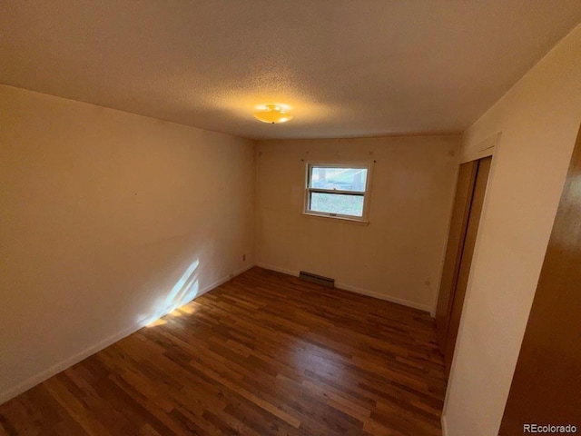 1013 Lexington Ln, Estes Park, CO 80517 - spare room with dark wood-type flooring and a textured ceiling