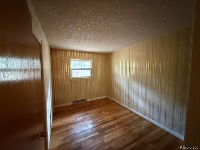 1013 Lexington Ln, Estes Park, CO 80517 - spare room with wood finished floors and a textured ceiling