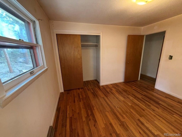 1013 Lexington Ln, Estes Park, CO 80517 - unfurnished bedroom featuring wood finished floors, a closet, and a textured ceiling
