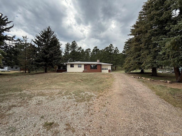 1013 Lexington Ln, Estes Park, CO 80517 - ranch-style house featuring driveway, a chimney, and a garage