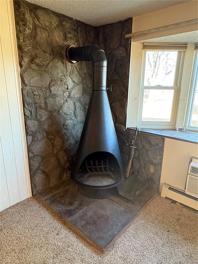 interior details with a baseboard radiator and a wood stove