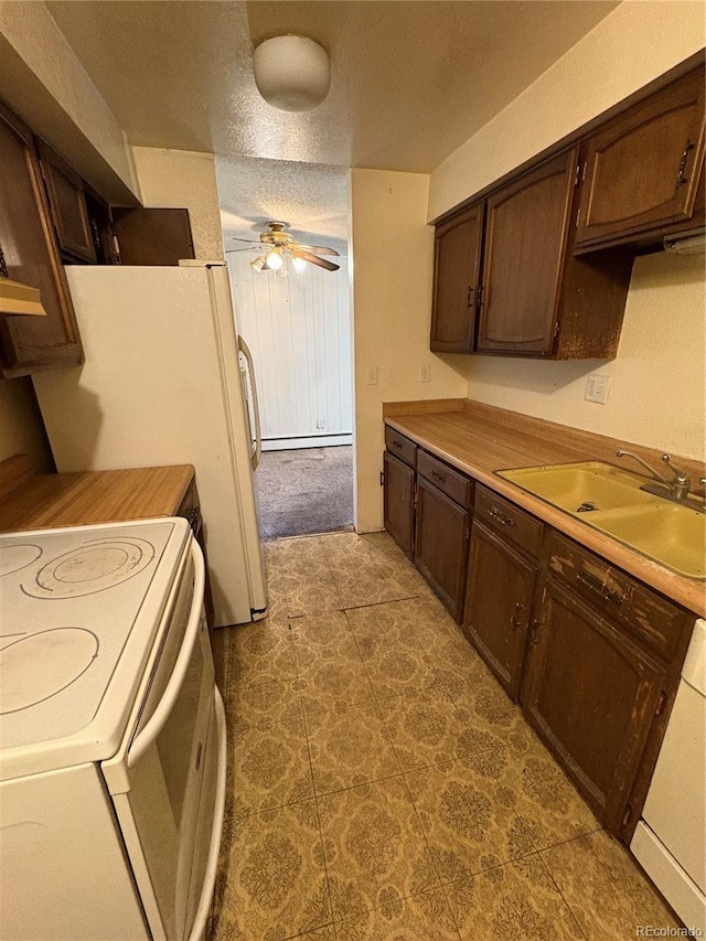 kitchen featuring white electric range oven, sink, a baseboard radiator, dishwashing machine, and ceiling fan