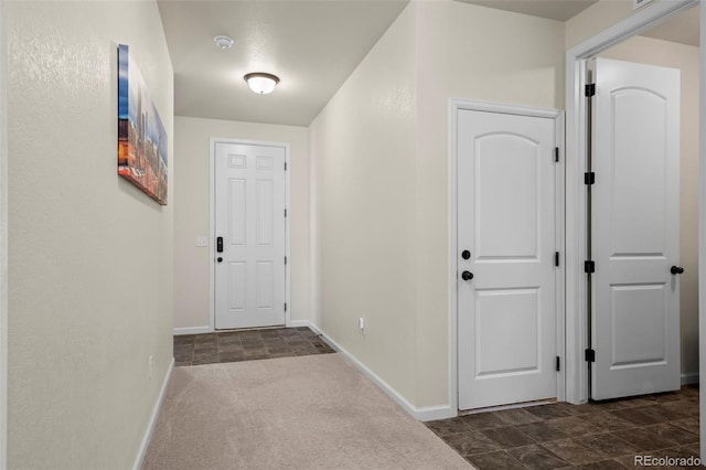 1868 Homestead Dr, Fort Lupton, CO 80621 - hallway with baseboards and dark colored carpet