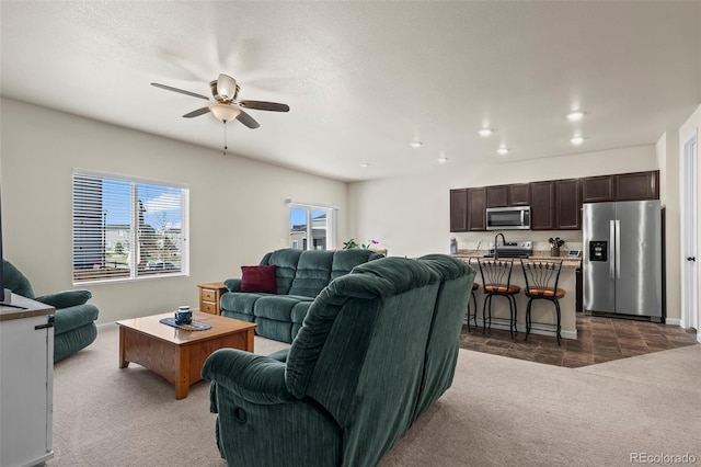 1868 Homestead Dr, Fort Lupton, CO 80621 - living area with dark carpet, ceiling fan, plenty of natural light, and recessed lighting
