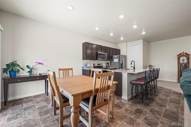 1868 Homestead Dr, Fort Lupton, CO 80621 - dining space with recessed lighting, baseboards, and dark stone finish flooring