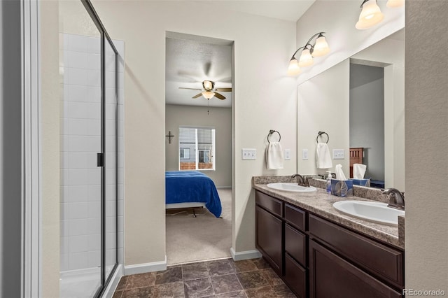 1868 Homestead Dr, Fort Lupton, CO 80621 - bathroom featuring ensuite bathroom, ceiling fan, a tile shower, double vanity, and baseboards
