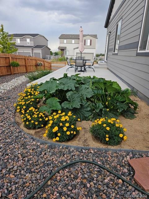 1868 Homestead Dr, Fort Lupton, CO 80621 - view of yard with fence, a patio, and outdoor dining space