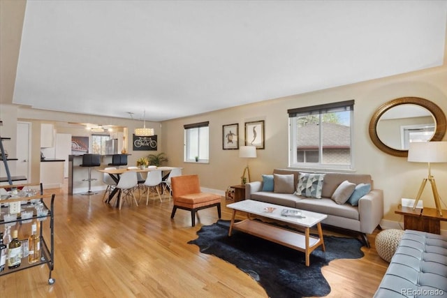 living room with light wood finished floors and baseboards