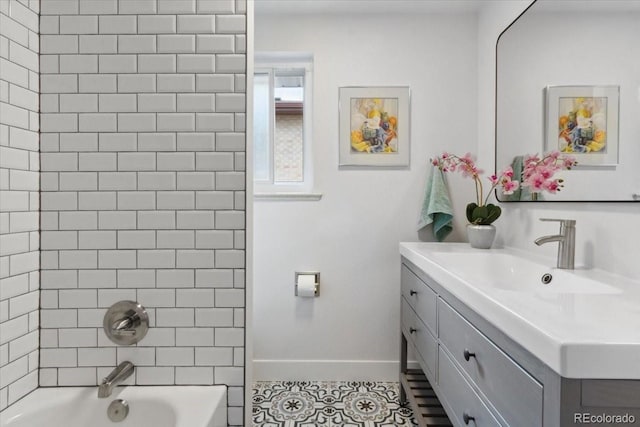 bathroom featuring tile patterned floors, baseboards, shower / bathing tub combination, and vanity