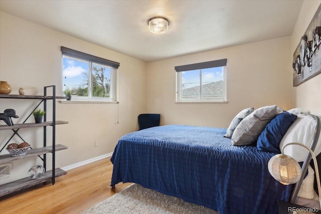 bedroom featuring wood finished floors and baseboards