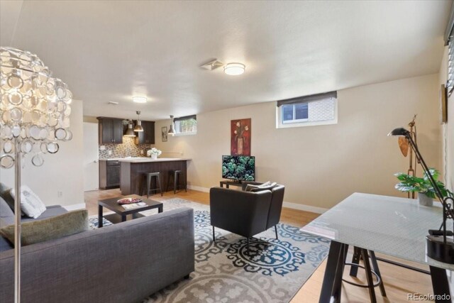 living room with light wood-style flooring and baseboards