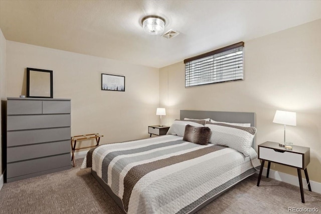 carpeted bedroom featuring visible vents and baseboards