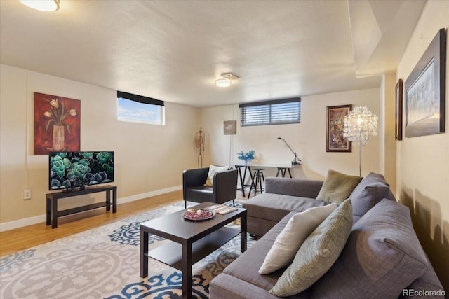 living room with baseboards and wood finished floors