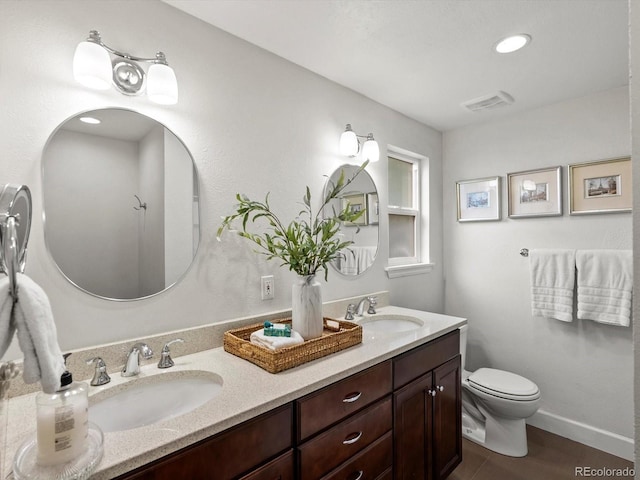 7055 E Heritage Pl S, Centennial, CO 80111 - bathroom featuring double vanity and toilet