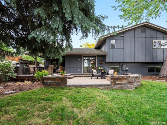7055 E Heritage Pl S, Centennial, CO 80111 - back of property with a yard, an outdoor fire pit, a patio, and board and batten siding