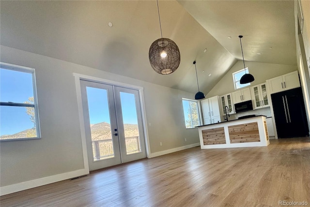 kitchen with a wealth of natural light, french doors, and black appliances