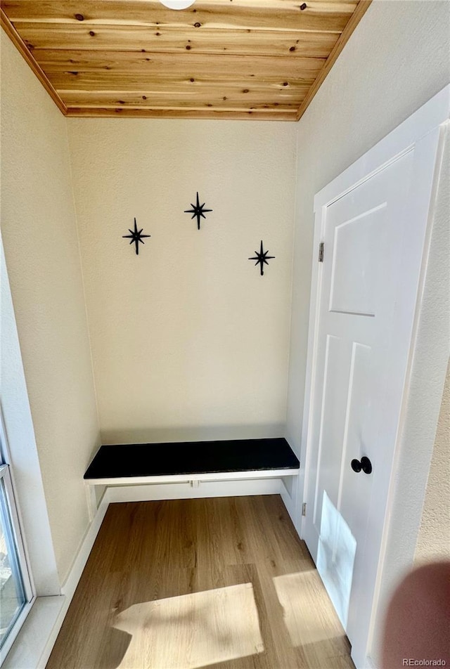 mudroom with wood ceiling, light wood-style flooring, and baseboards