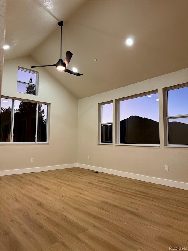 unfurnished room featuring baseboards, a ceiling fan, and wood finished floors