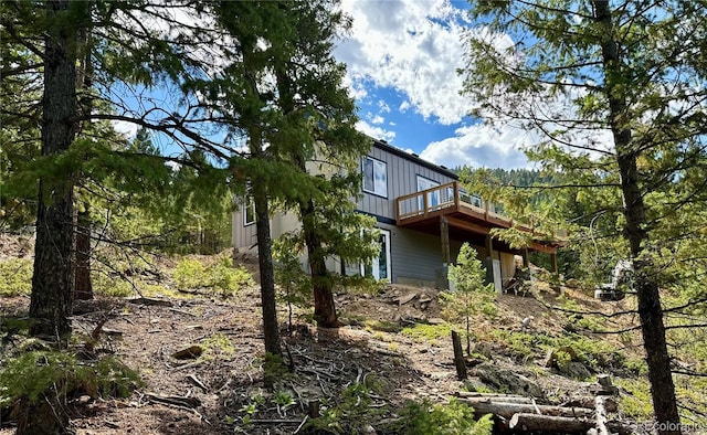 view of side of property with a wooden deck