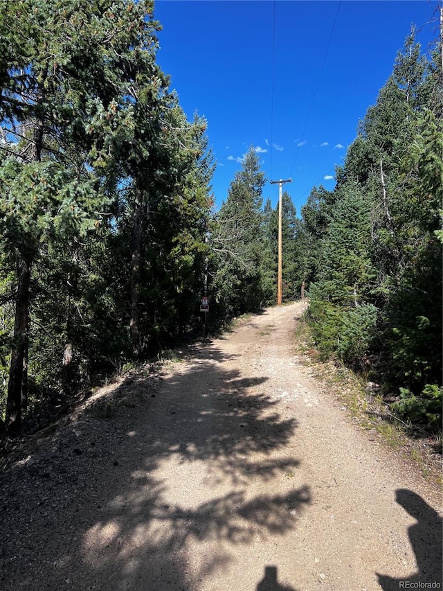 view of road featuring a forest view