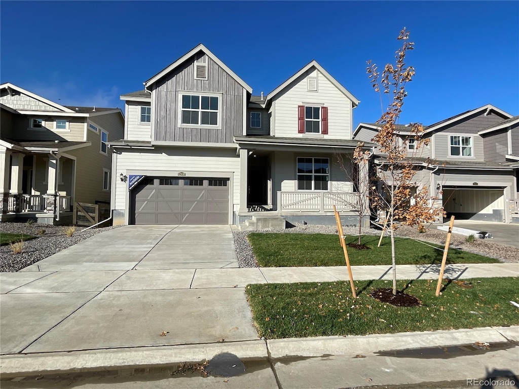 view of front of property with covered porch and a garage