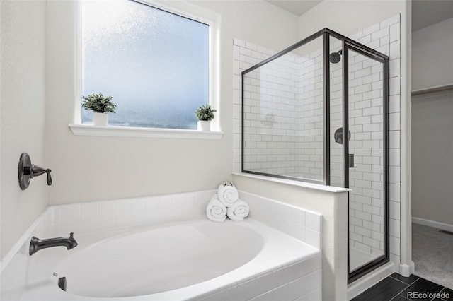 full bathroom featuring visible vents, a garden tub, and a shower stall