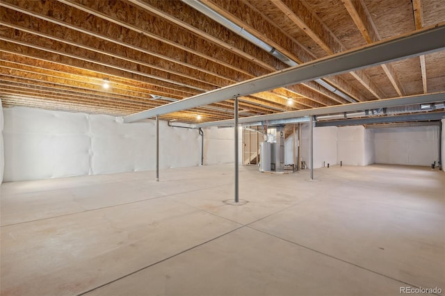 unfinished basement featuring water heater