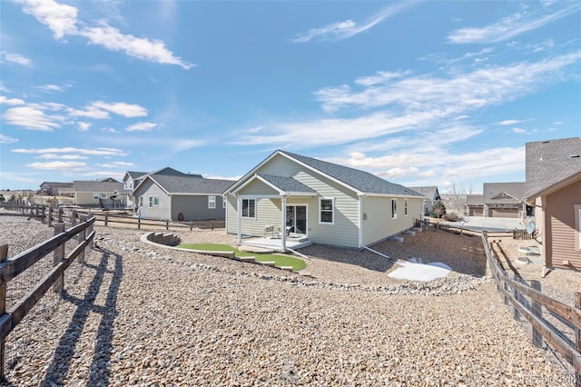 view of front of home featuring a residential view, a patio area, and a fenced backyard