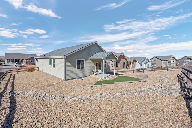 back of house with a residential view, a patio area, and fence