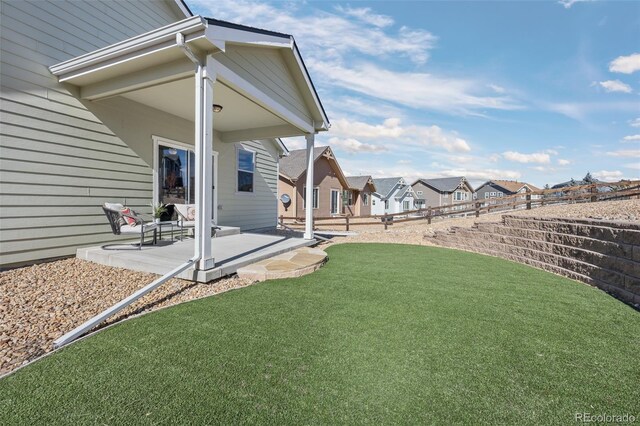 view of yard with a patio area and a residential view