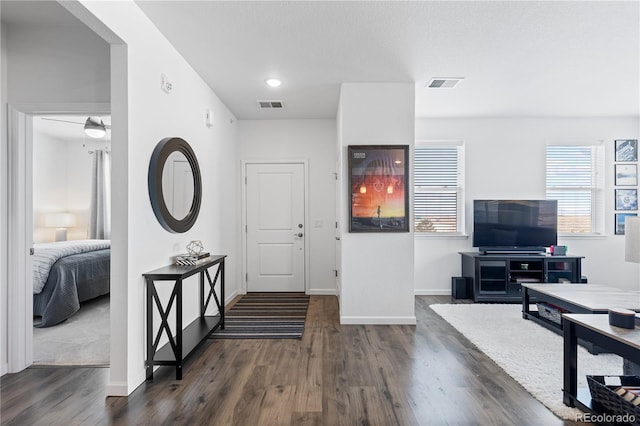 entryway featuring visible vents, baseboards, and dark wood finished floors