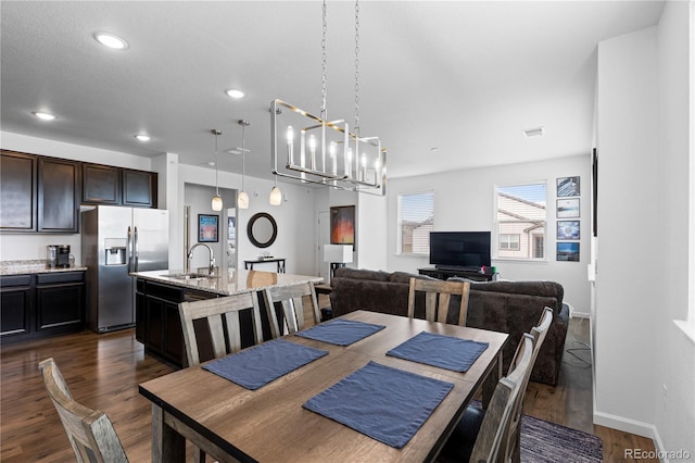dining area with recessed lighting, a notable chandelier, visible vents, and dark wood finished floors