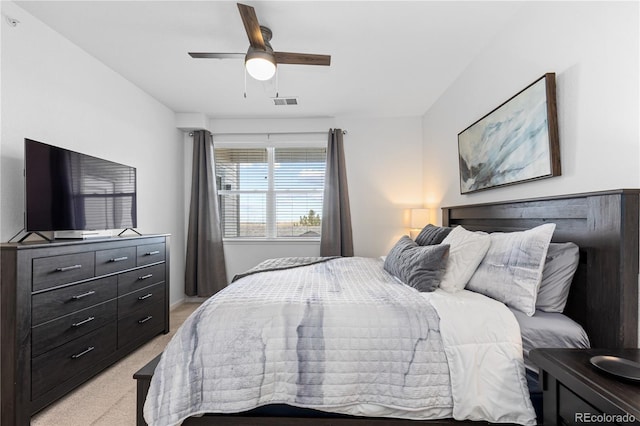 bedroom featuring light carpet, ceiling fan, and visible vents