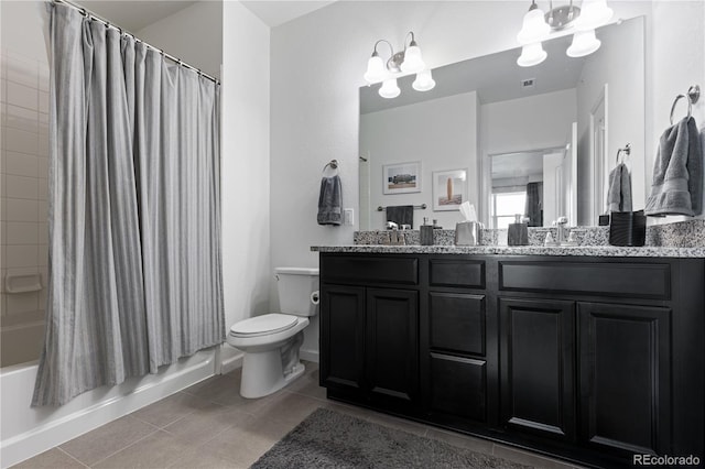 full bath featuring an inviting chandelier, a sink, toilet, double vanity, and tile patterned flooring
