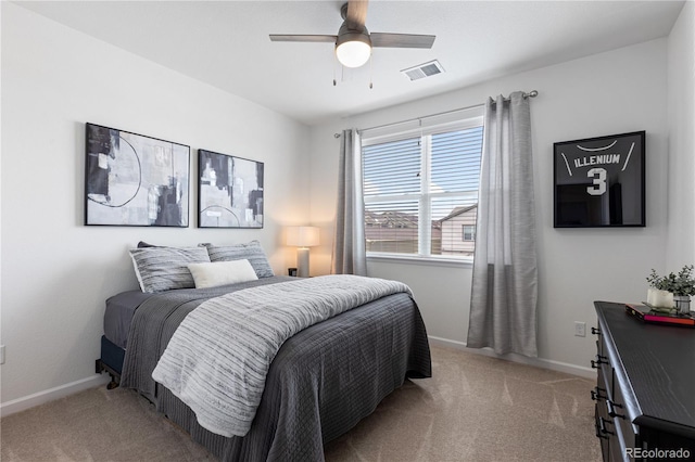 bedroom featuring visible vents, light colored carpet, baseboards, and a ceiling fan